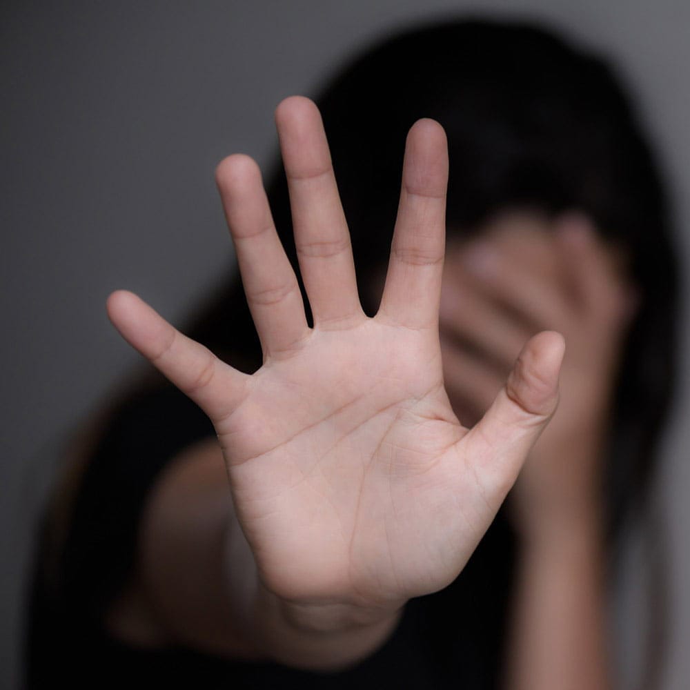 Sex Crimes - Woman holding her hand up in a protective gesture.