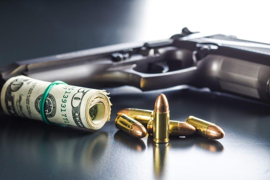 9mm bullets, american dollars and handgun.