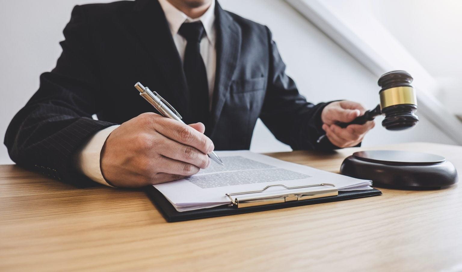 Judge gavel with Justice lawyers, counselor in suit or lawyer working on a documents at law firm in office. Legal law, advice and justice concept.