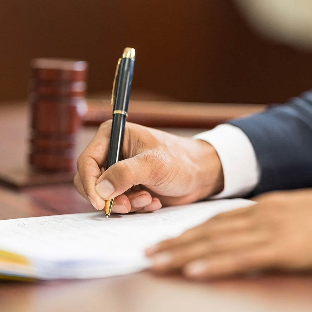 Attorney signing a document.